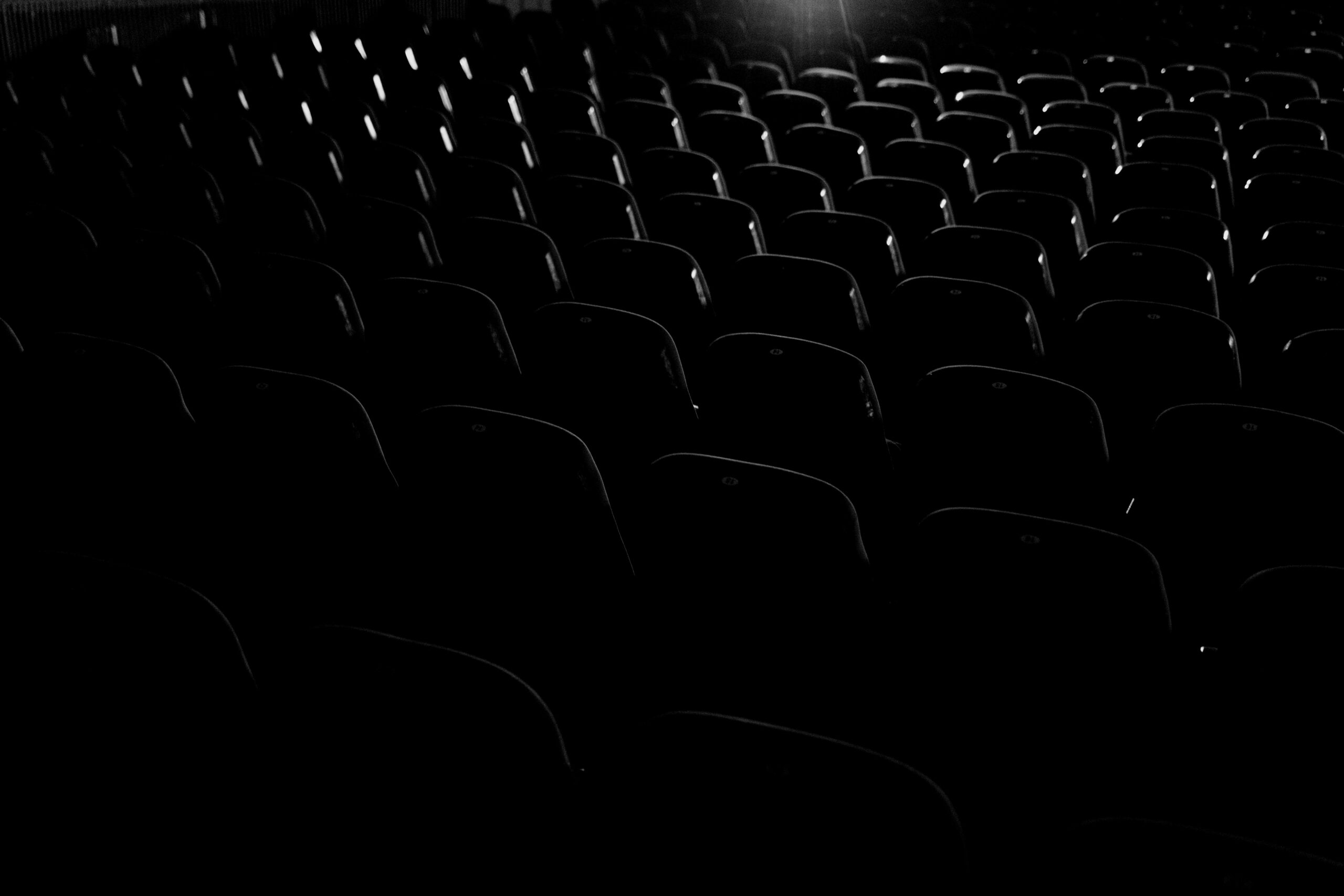 Rows of empty theater seats in low light